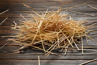 Photo of Heap of dried hay on wooden background