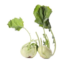 Whole ripe kohlrabies with leaves on white background
