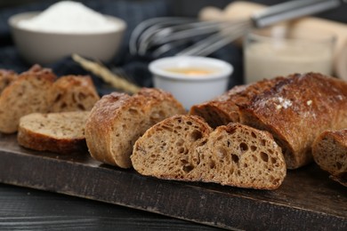 Photo of Freshly baked bread on wooden table, closeup