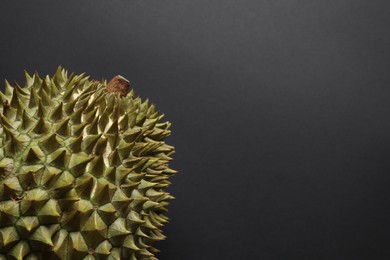 Fresh ripe durian on black background, closeup. Space for text