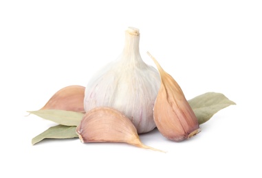 Fresh garlic bulb and cloves with bay leaves isolated on white. Organic food