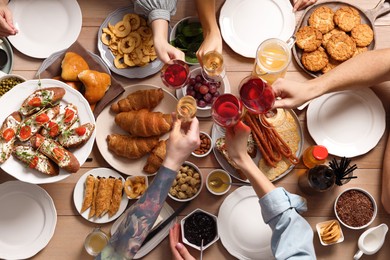Group of people having brunch together at table, top view