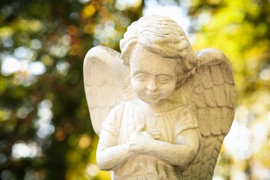 Photo of Beautiful statue of angel at cemetery, closeup. Religious symbol