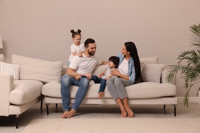 Happy family resting on sofa in living room