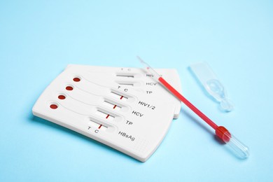 Disposable express hepatitis test kit on light blue background