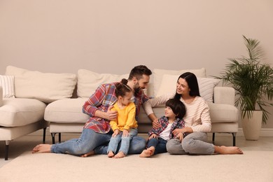 Photo of Happy family spending time together in living room