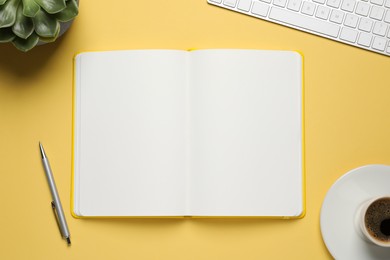 Photo of Flat lay composition with stylish notebook on yellow background