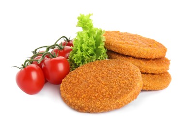 Delicious fried breaded cutlets with cherry tomatoes and lettuce on white background