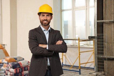 Portrait of professional engineer in hard hat indoors