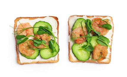 Photo of Tasty toasts with cream cheese, shrimps, cucumbers and microgreens on white background, top view