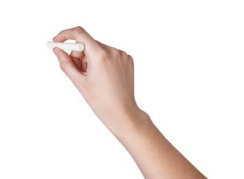 Woman holding piece of chalk isolated on white, closeup