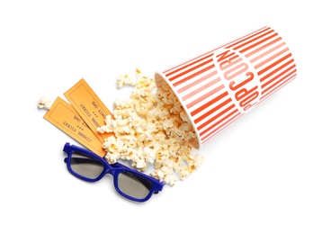 Bucket of fresh popcorn, tickets and 3D glasses on white background, top view. Cinema snack