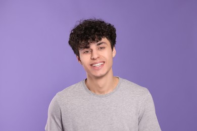 Photo of Portrait of handsome young man on violet background