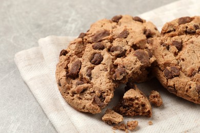 Photo of Delicious chocolate chip cookies on light grey table, closeup
