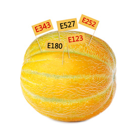 Fresh melon with E numbers isolated on white. Harmful food additives 