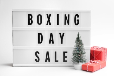 Lightbox with phrase BOXING DAY SALE and Christmas decorations on white background