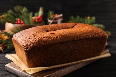 Delicious gingerbread cake on black wooden table, closeup