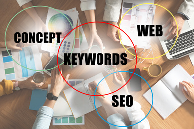 Image of Keywords research concept. Team of SEO specialists working at table, top view