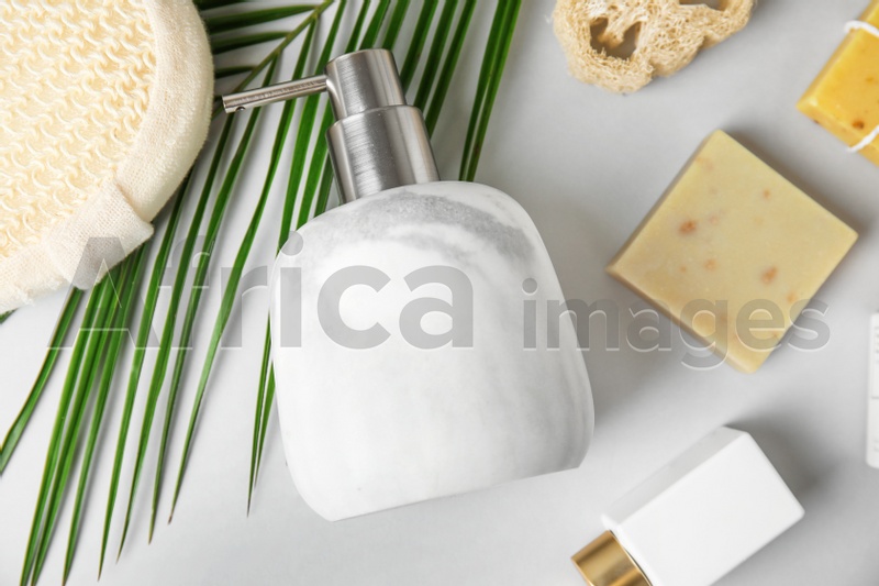 Flat lay composition with marble soap dispenser on white background
