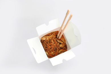Photo of Chinese noodles in paper box, top view. Food delivery