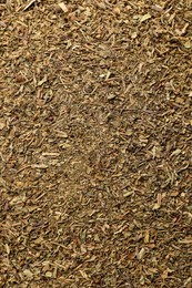 Aromatic dried basil as background, top view