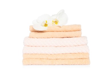Stack of clean soft towels with orchids isolated on white