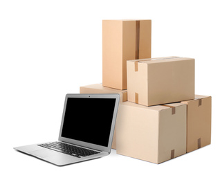 Online selling. Laptop and parcels on white background