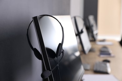 Modern computer with headset in office. Hotline service
