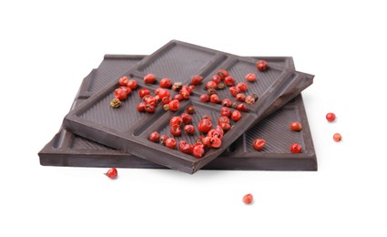 Photo of Dark chocolate pieces with red peppercorns isolated on white