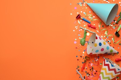 Beautiful flat lay composition with festive items on orange background, space for text. Surprise party concept