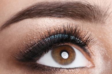 Young woman with eyelash extensions and beautiful makeup, closeup view
