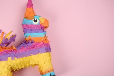 Photo of Bright donkey pinata on pink background, top view. Space for text