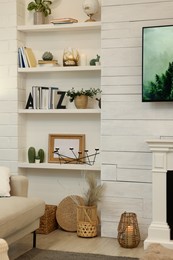 Shelves with different decor in room. Interior design