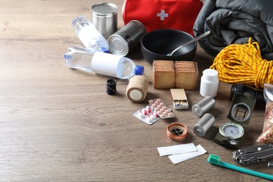 Earthquake supply kit on wooden table. Space for text