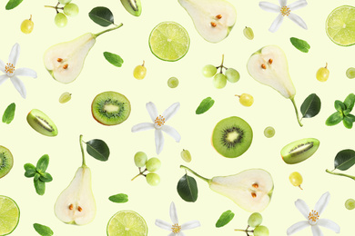 Tropical layout with fresh exotic fruits and mint leaves on pale light green background, top view