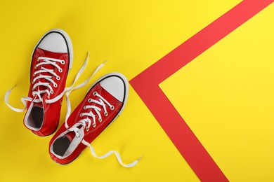 Photo of Pair of trendy sneakers on color background, flat lay. Space for text