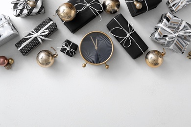 Flat lay composition with alarm clock and Christmas decor on white background, space for text. New Year countdown