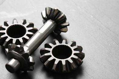 Photo of Different stainless steel gears on light grey background, closeup. Space for text