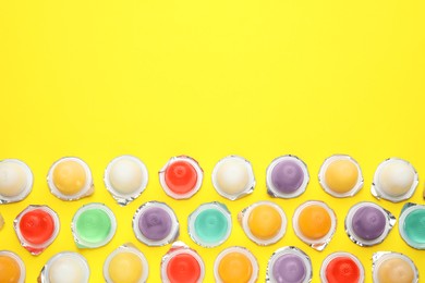 Tasty bright jelly cups  on yellow background, flat lay. Space for text