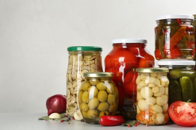 Jars of pickled vegetables on light table