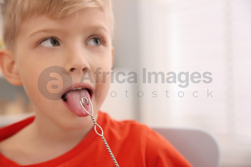 Little boy doing exercise with logopedic probe at speech therapist office, closeup