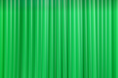 Heap of green plastic straws for drinks as background, closeup