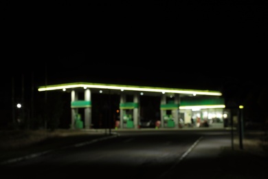 Blurred view of modern gas station at night outdoors