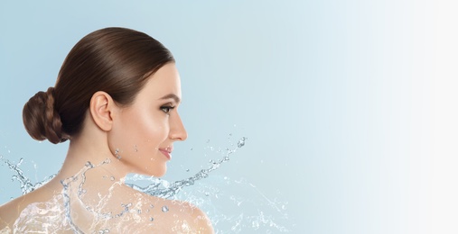 Beautiful young woman and splashing water on light background, space for text. Spa portrait