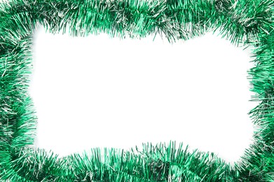 Frame of shiny green tinsel on white background, top view. Space for text