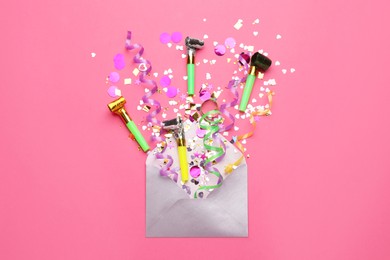 Photo of Beautiful flat lay composition with envelope and festive items on pink background. Surprise party concept
