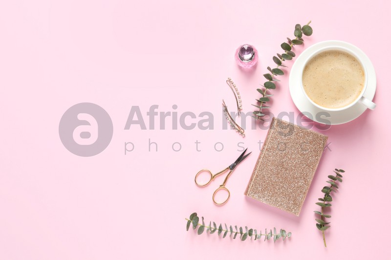 Flat lay composition with scissors, coffee and notebook on pink background. Space for text