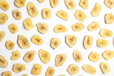Flat lay composition with banana slices on  white background. Dried fruit as healthy snack