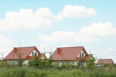 Modern buildings with red roofs outdoors on spring day