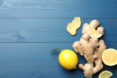 Photo of Fresh lemons and ginger on blue wooden table, flat lay. Space for text
